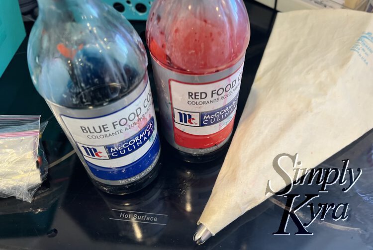 Image shows a piping bag with the tip already in it and both red and blue food coloring.