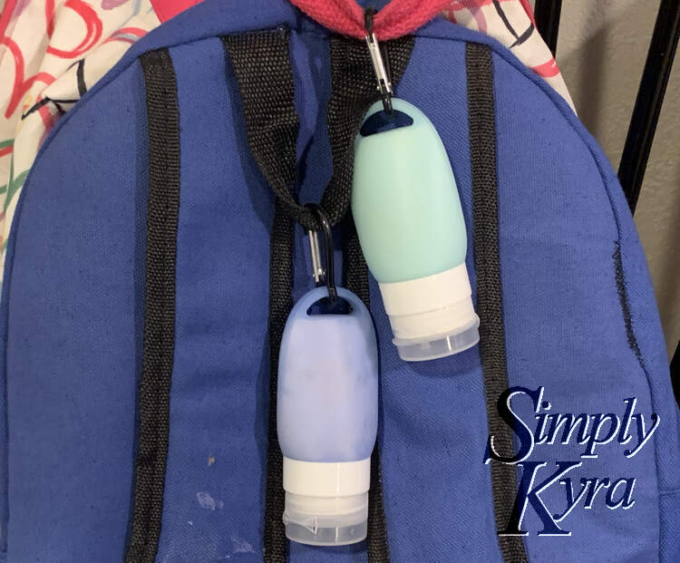 Image is from last year and shows the back of two backpacks with the newly bought and filled tubes hanging from the top. 