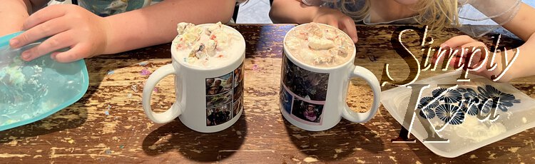 Short and wide image showing the mugs with whip cream and sprinkles placed in it while the kids reach for more in their Stasher bags. 