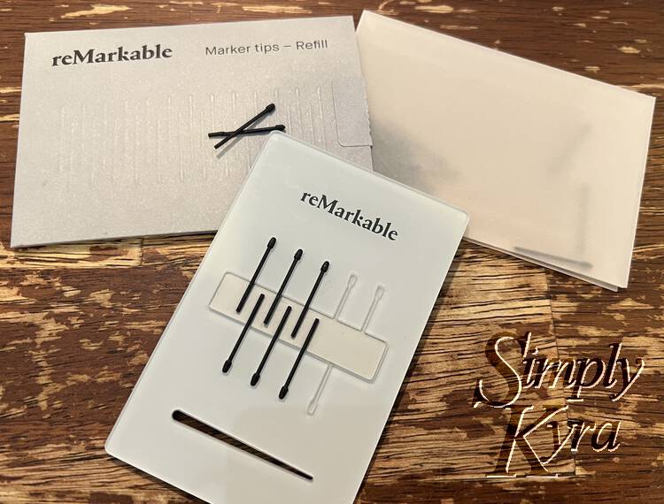 Image shows six tips in the marker tip card with the refill package and two loose tips behind it. 