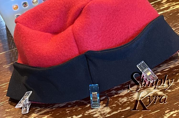 Image shows the hat top with the black band lined up and clipped together along the bottom edge.