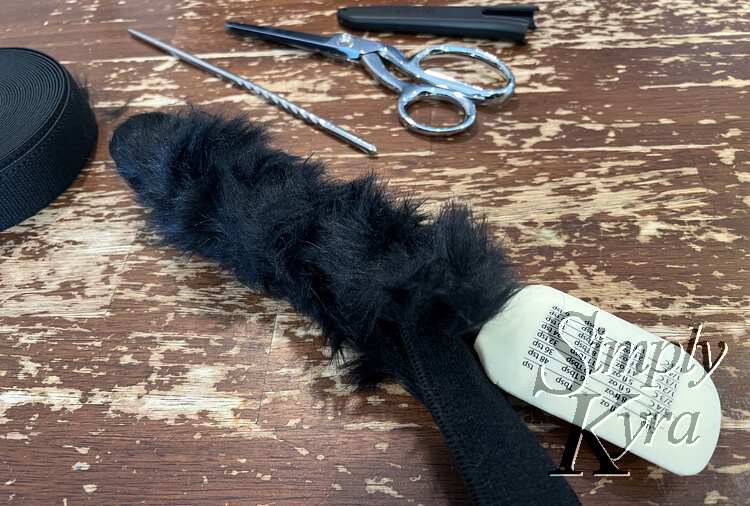 Image shows the handle of my spatula stuck inside the cat tail as it helps push the tail right side out.