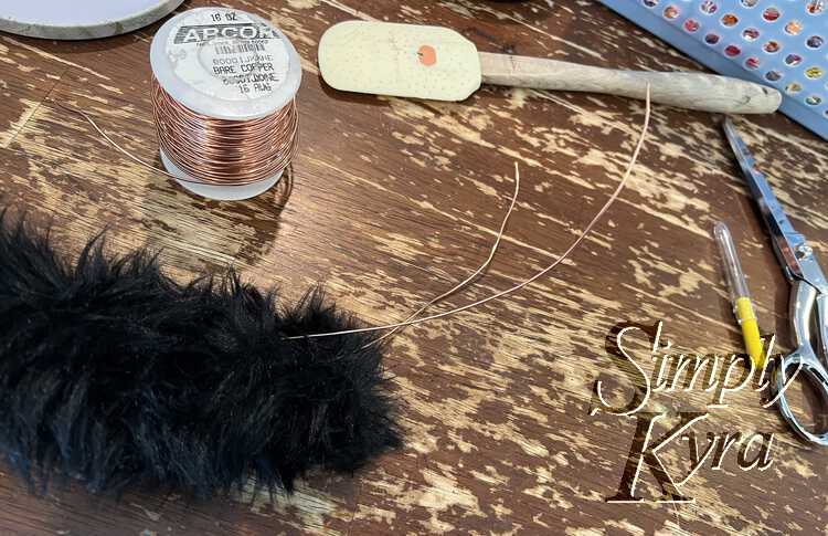 Image shows the two ends of the wire sticking out of the tail.