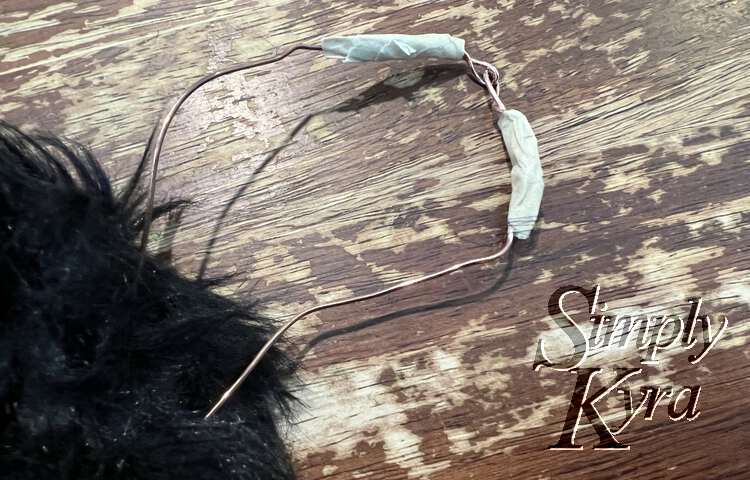 Image shows the loops still visible but there's now masking tape hiding the wire twists.