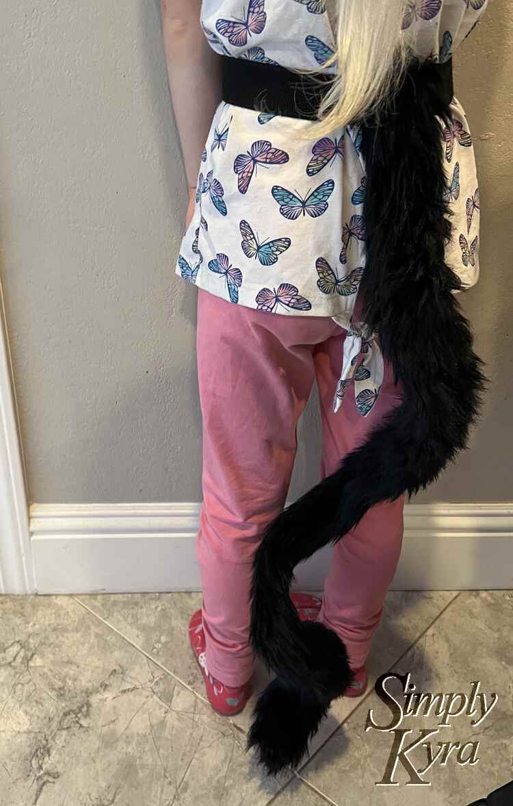 Image shows the back of Zoey with a black curling tail descending from her black plush elastic waistband.