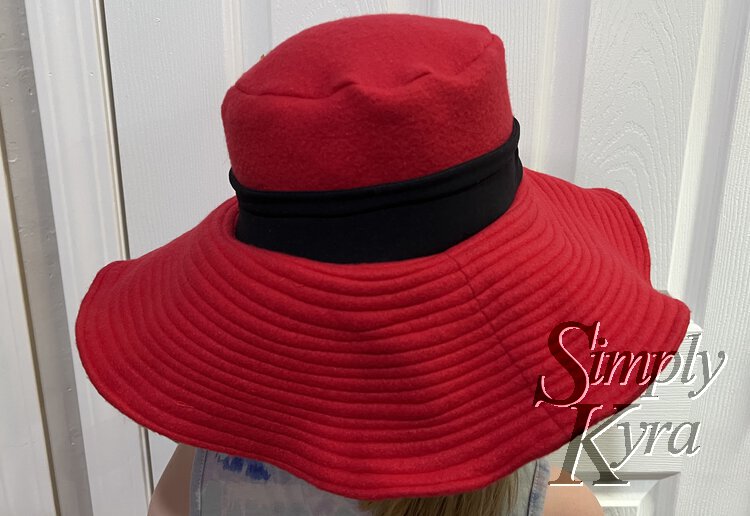 Image shows the finished hat on Ada's head.