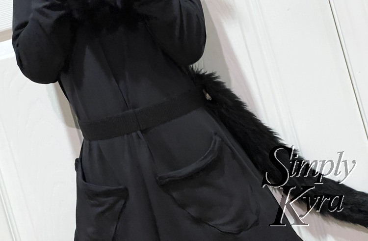 Image shows the tail from the front but this time placed around a black dress. Now it blends in rather than popping like the previous photo. 