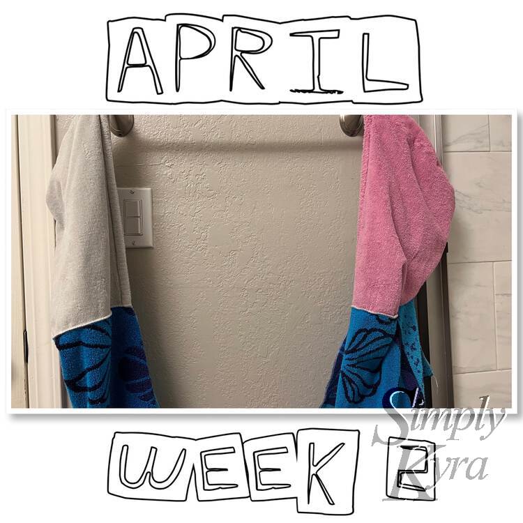 Image shows a single photo of the newly fixed towels on either side of a curtain rod. Above it says "April" while below it says "Week 2".