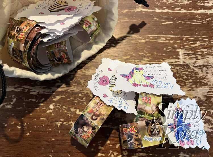 Image shows a bag of finished valentine's with three pulled out and sitting on table to show them better. 